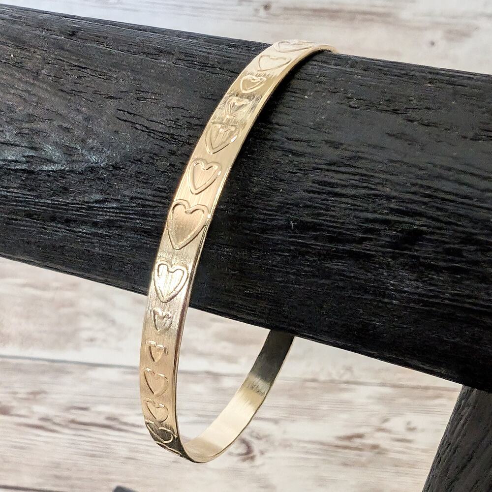 Gold Tone Cuff Bracelet with Heart Pattern Design